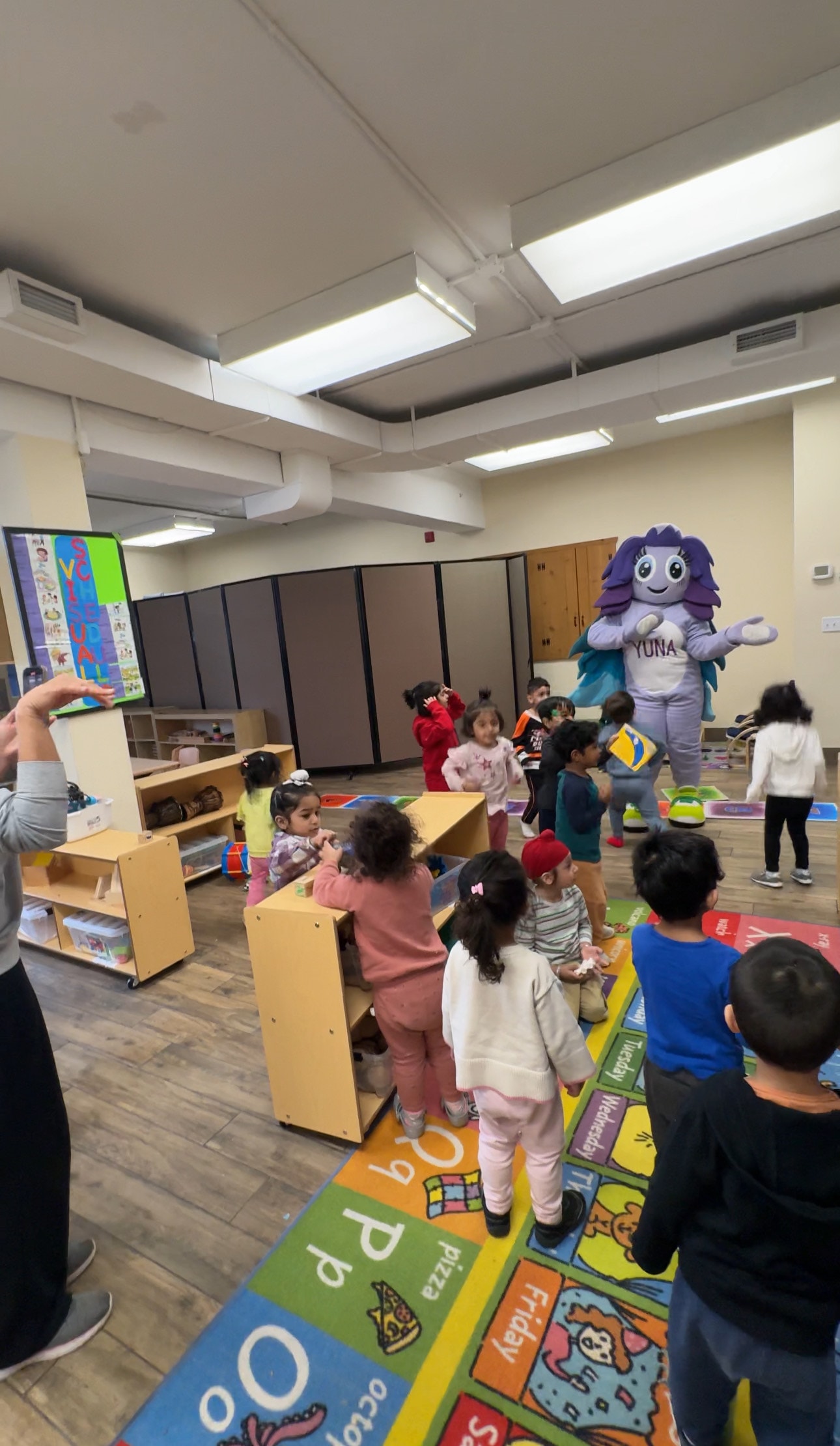 Yuna mascot visiting the preschool classroom — children dancing and playing