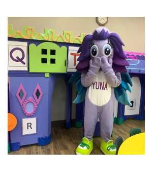 Yuna mascot posing in the colourful preschool classroom