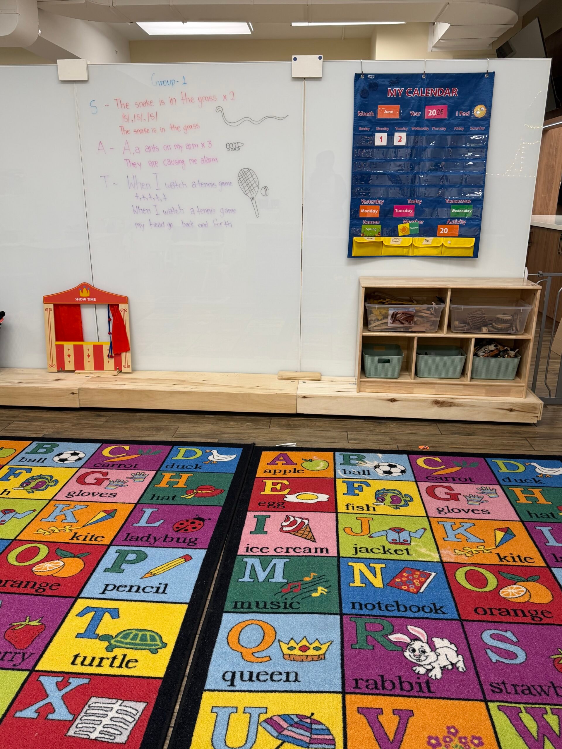 Preschool classroom with colourful alphabet floor tiles and learning wall